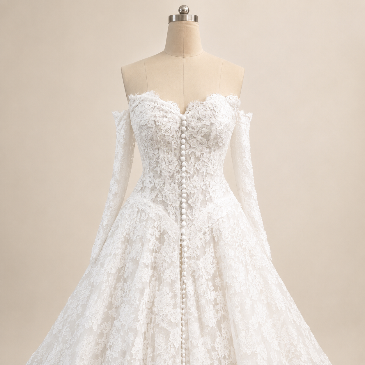 Close up front view of Estelle basque waist lace wedding gown shown with structured bodice lining and removable off-the-shoulder sleeves