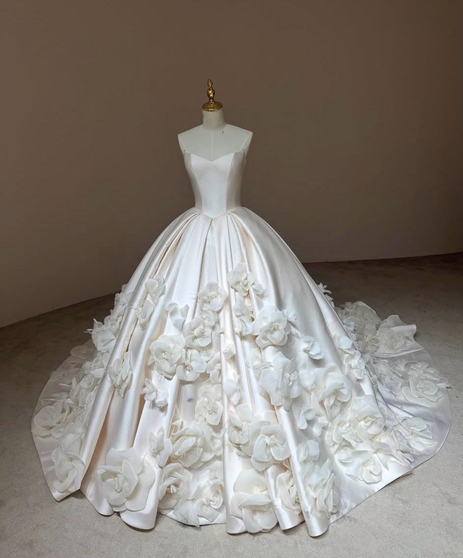 Three-quarter view of Camellia Royale floral wedding dress with a structured basque corset and voluminous Mikado satin skirt.