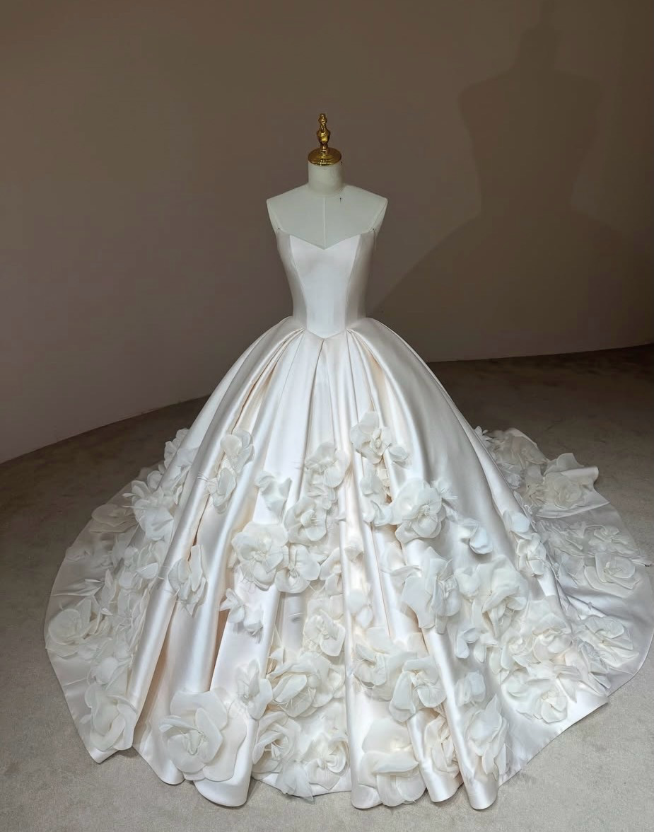front view of Camellia Royale premium Mikado satin ball gown with a pointed basque waist, sweetheart neckline, and handmade 3D floral skirt.