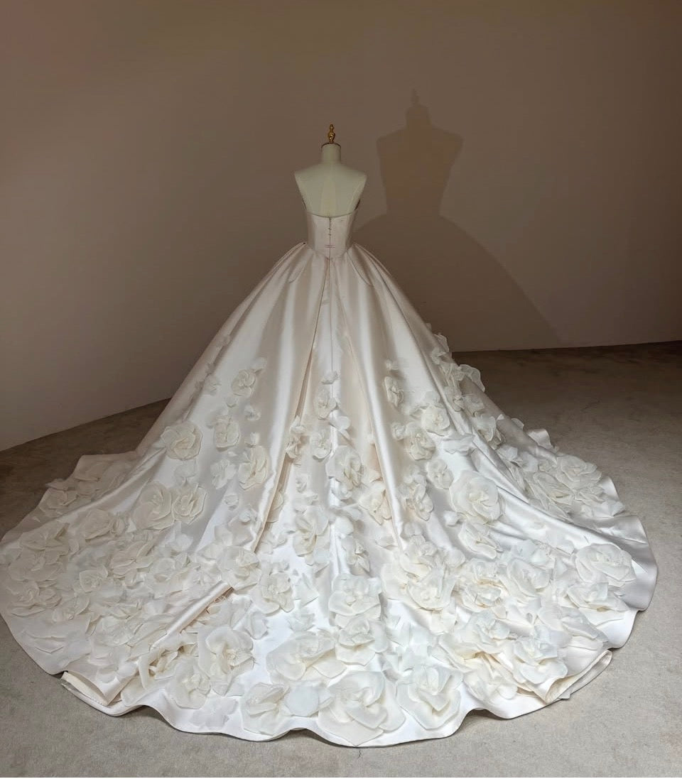 Back view of Camellia Royale premium Mikado satin wedding gown with zipper closure and a floral cathedral train.