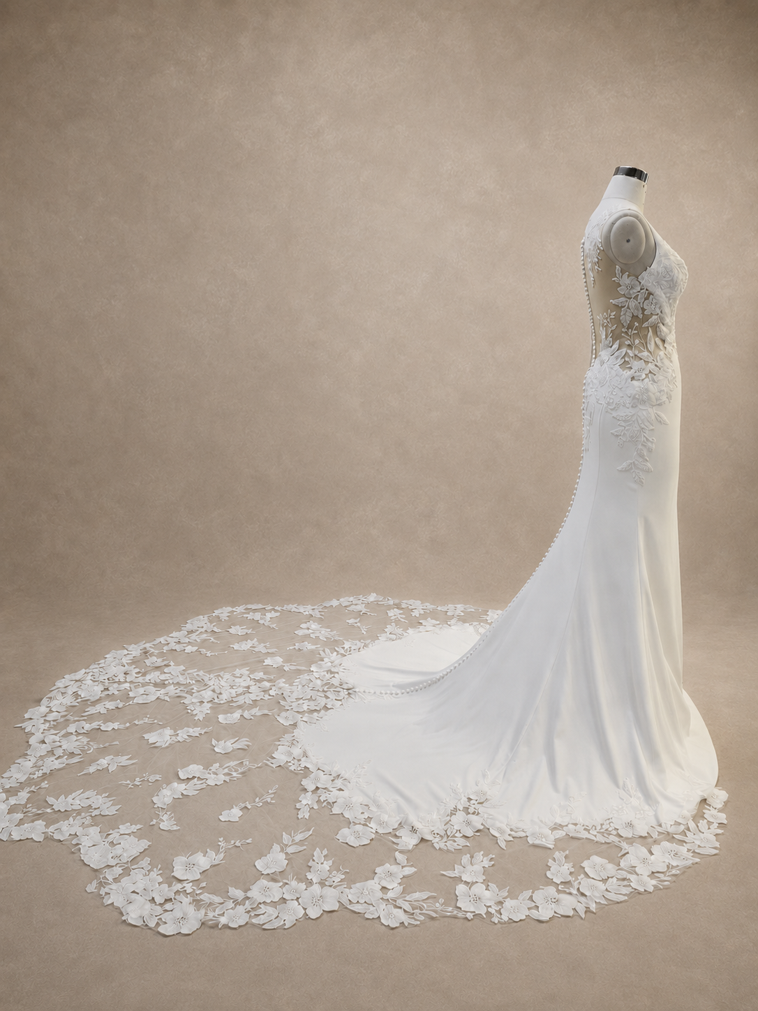 valessine-fitted-satin-wedding-dress-side-view.webp
Alt: Side view of Valessine fitted satin wedding dress and sheer embroidered floral train