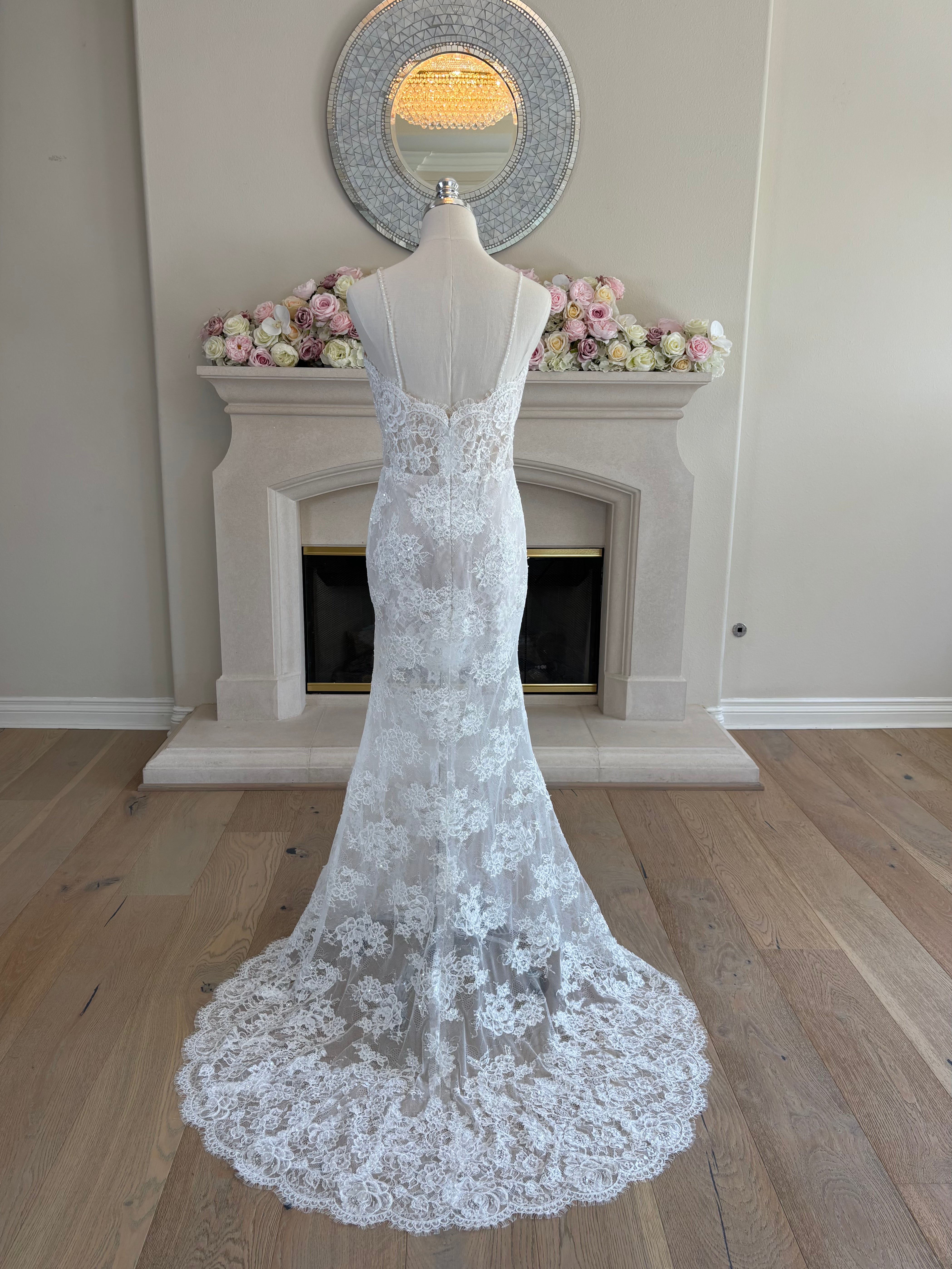 Back view of Amélie French floral lace fit-and-flare wedding dress shown without the detachable satin overskirt