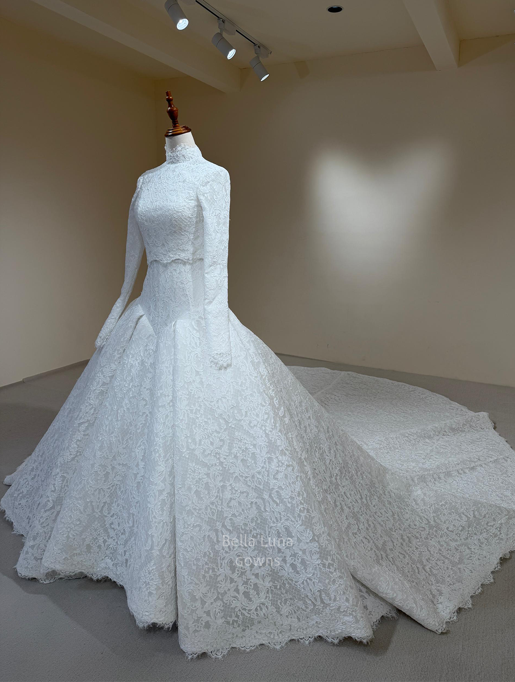 three quarter front view of Two-piece French lace wedding dress with removable long-sleeve bolero