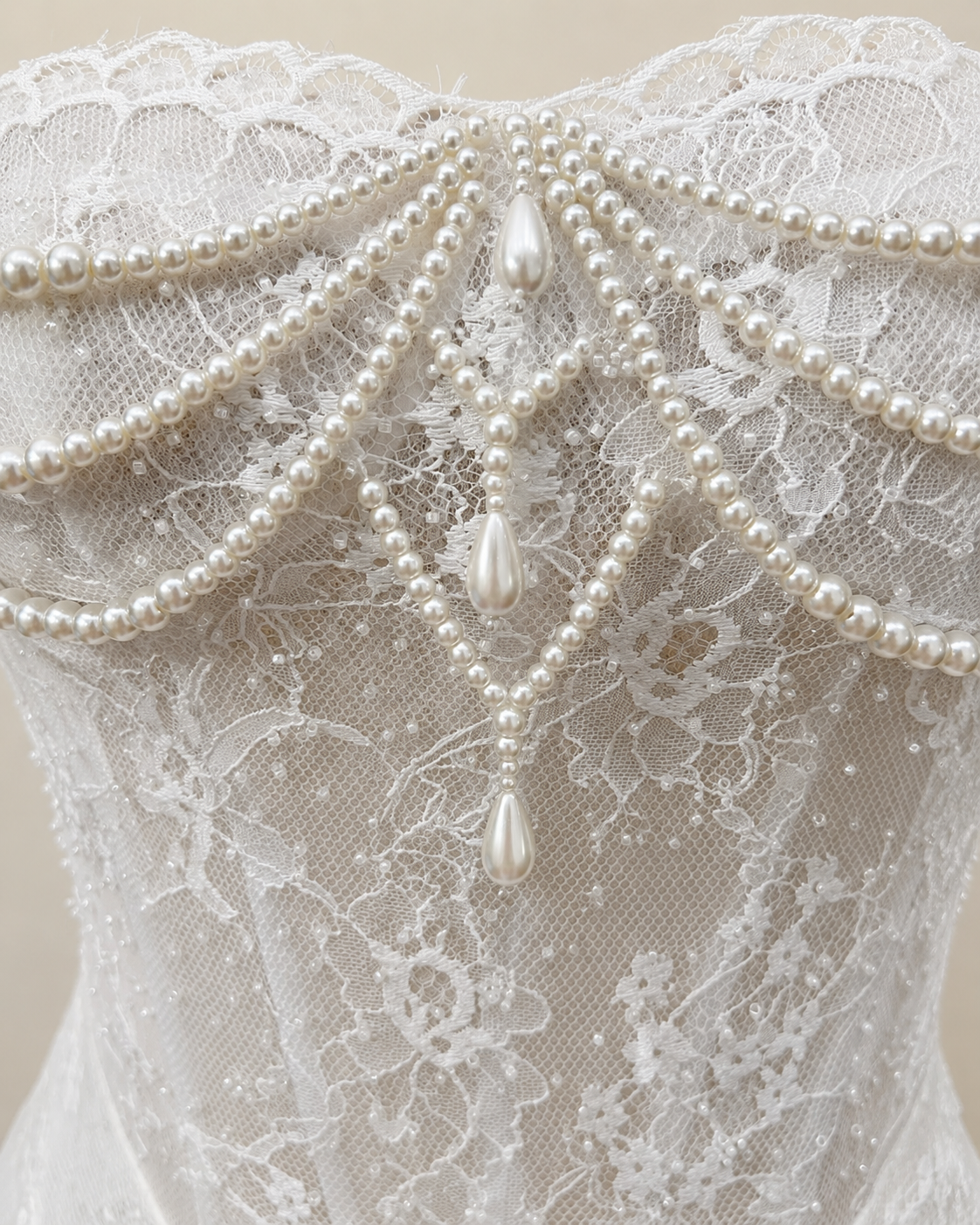 Marielle pearl draped lace wedding gown bodice close-up with sweetheart neckline, beaded lace and teardrop pearl accents