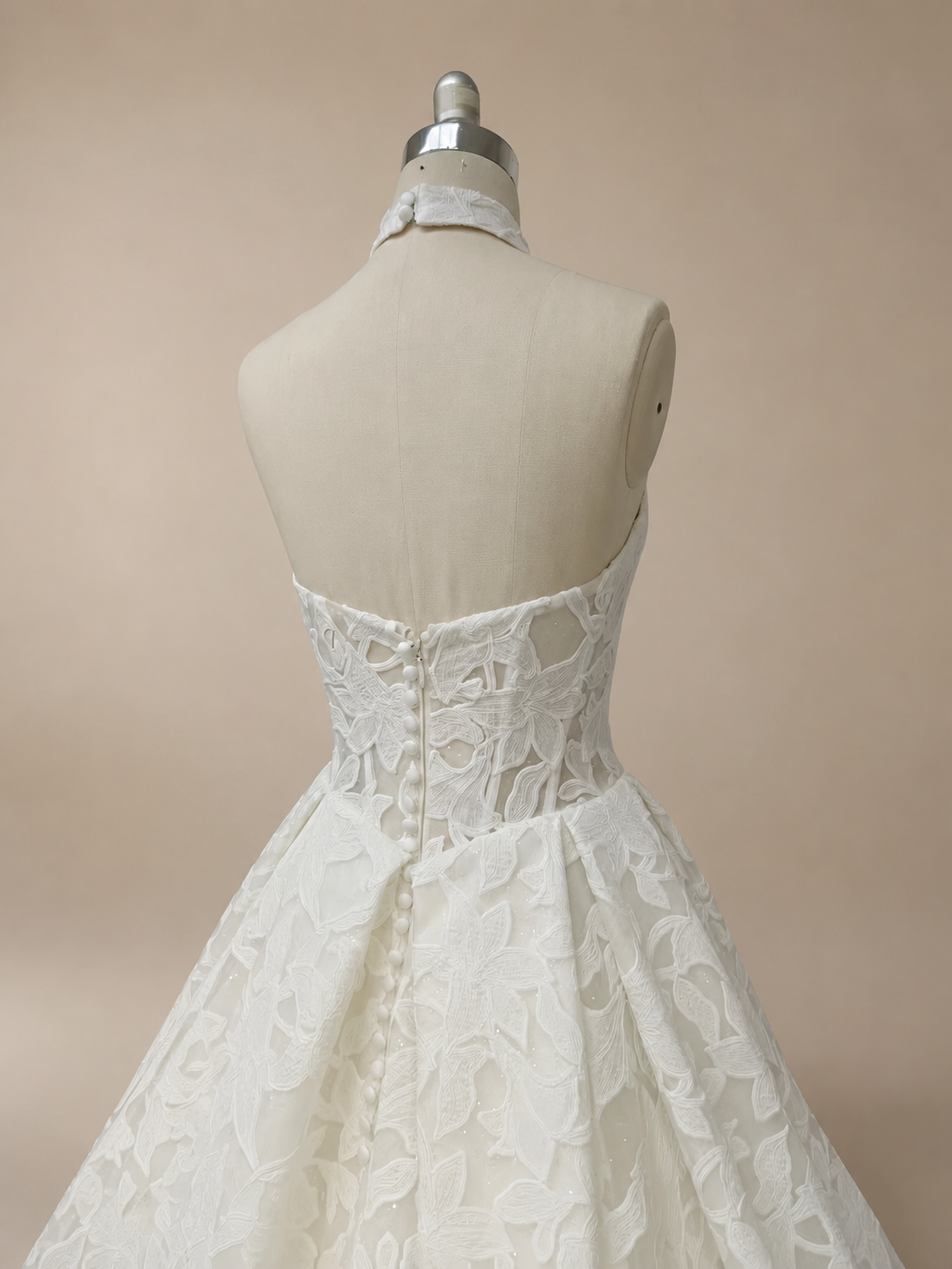 Back view of Solenne halter lace bridal gown with open back and covered button closure
