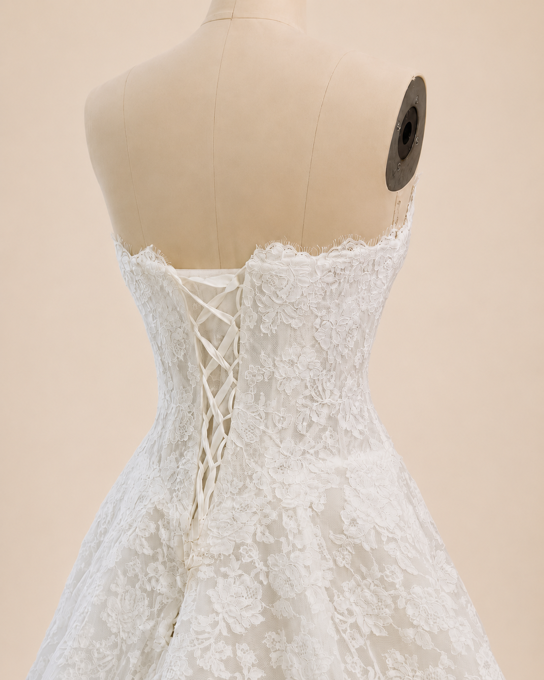 Back close-up of Estelle corded lace bridal gown showing adjustable lace-up corset closure and structured drop waist bodice