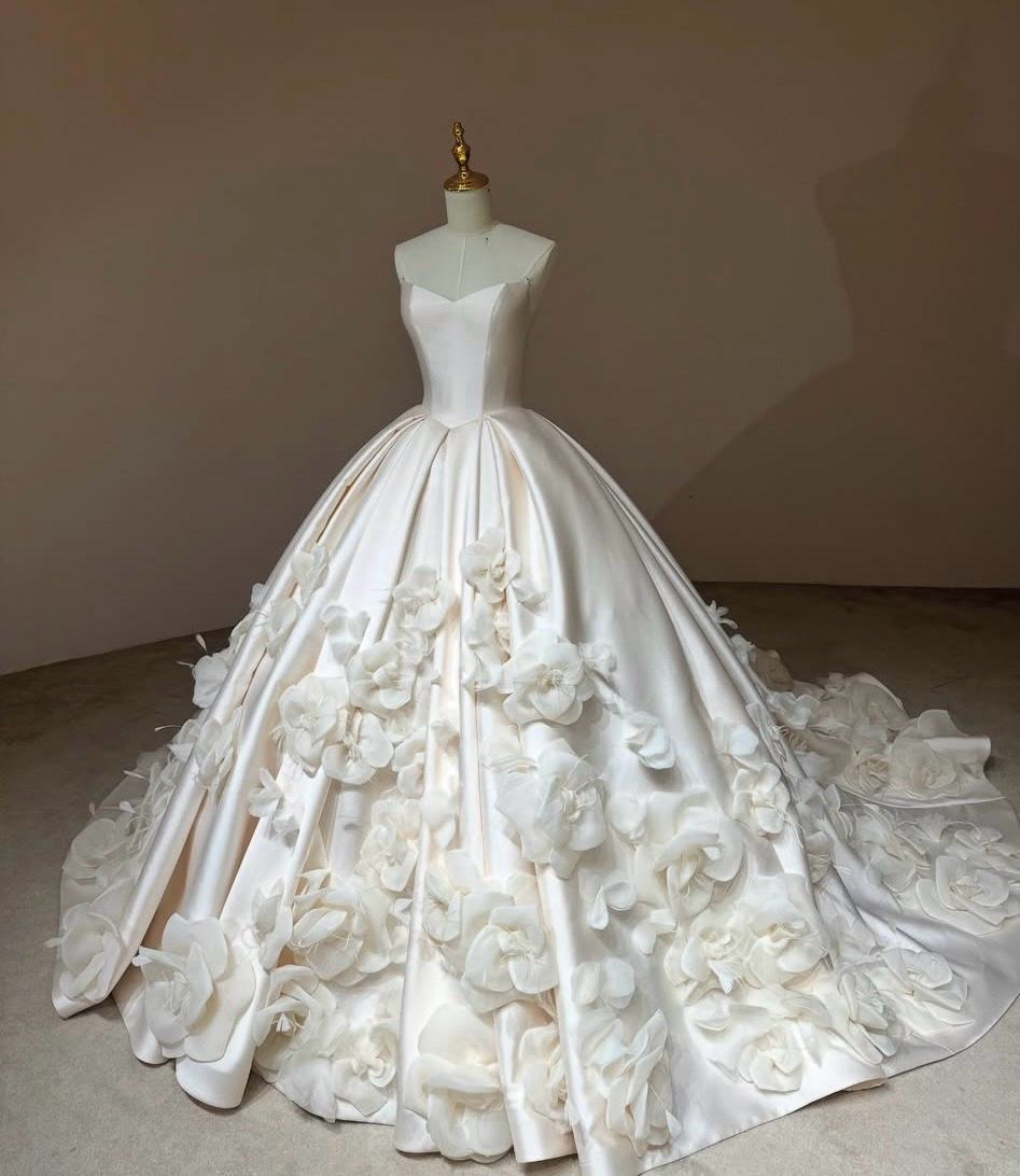 Camellia Royale premium Mikado satin ball gown with a pointed basque waist, sweetheart neckline, and handmade 3D floral skirt.