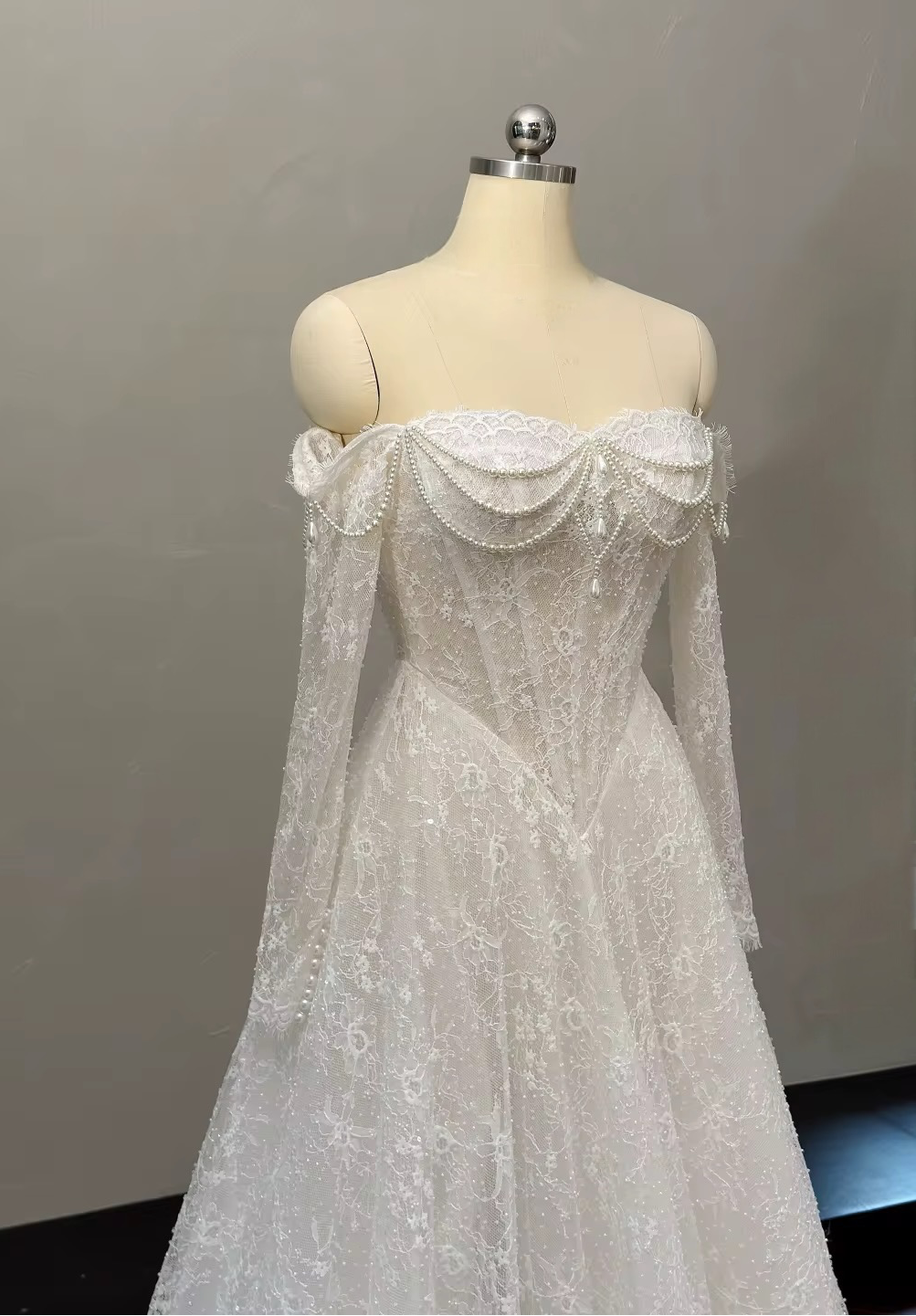 Marielle romantic lace wedding dress angled view highlighting pearl neckline draping and structured corset bodice