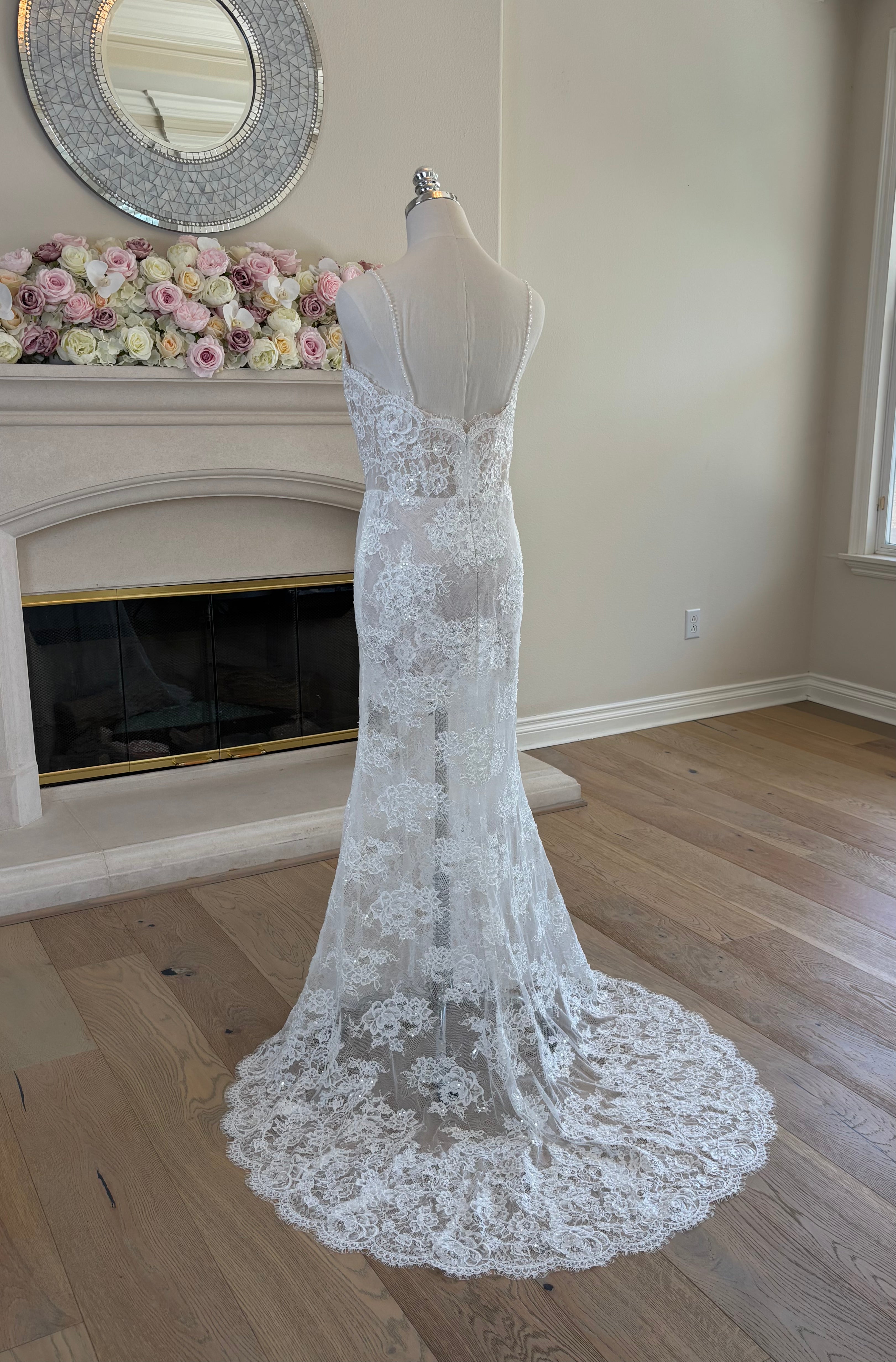 three quarter back view of Amélie French floral lace fit-and-flare wedding dress shown without the detachable satin overskirt