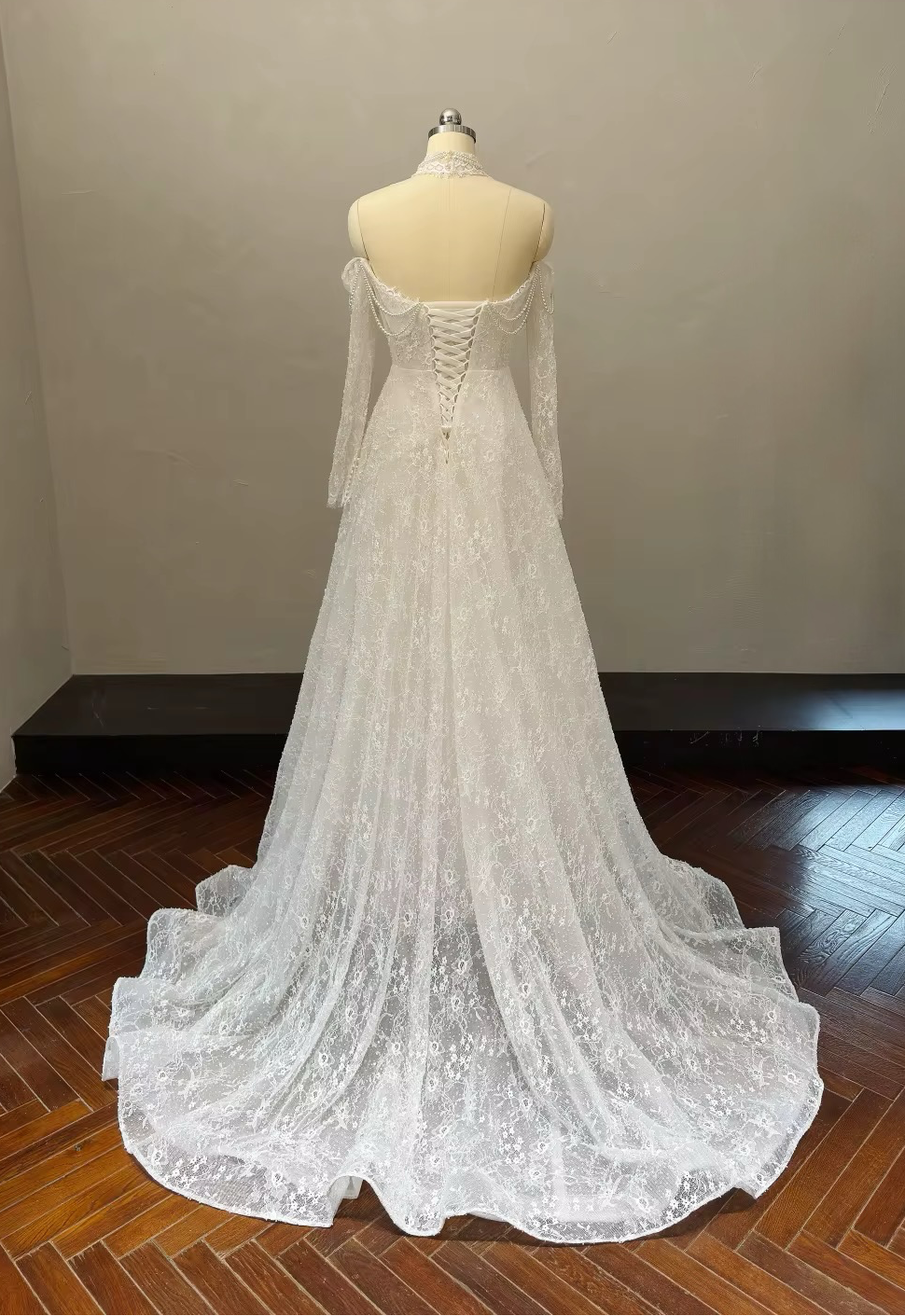 Marielle A-line lace wedding gown back view with lace-up corset closure, long sleeves and chapel train