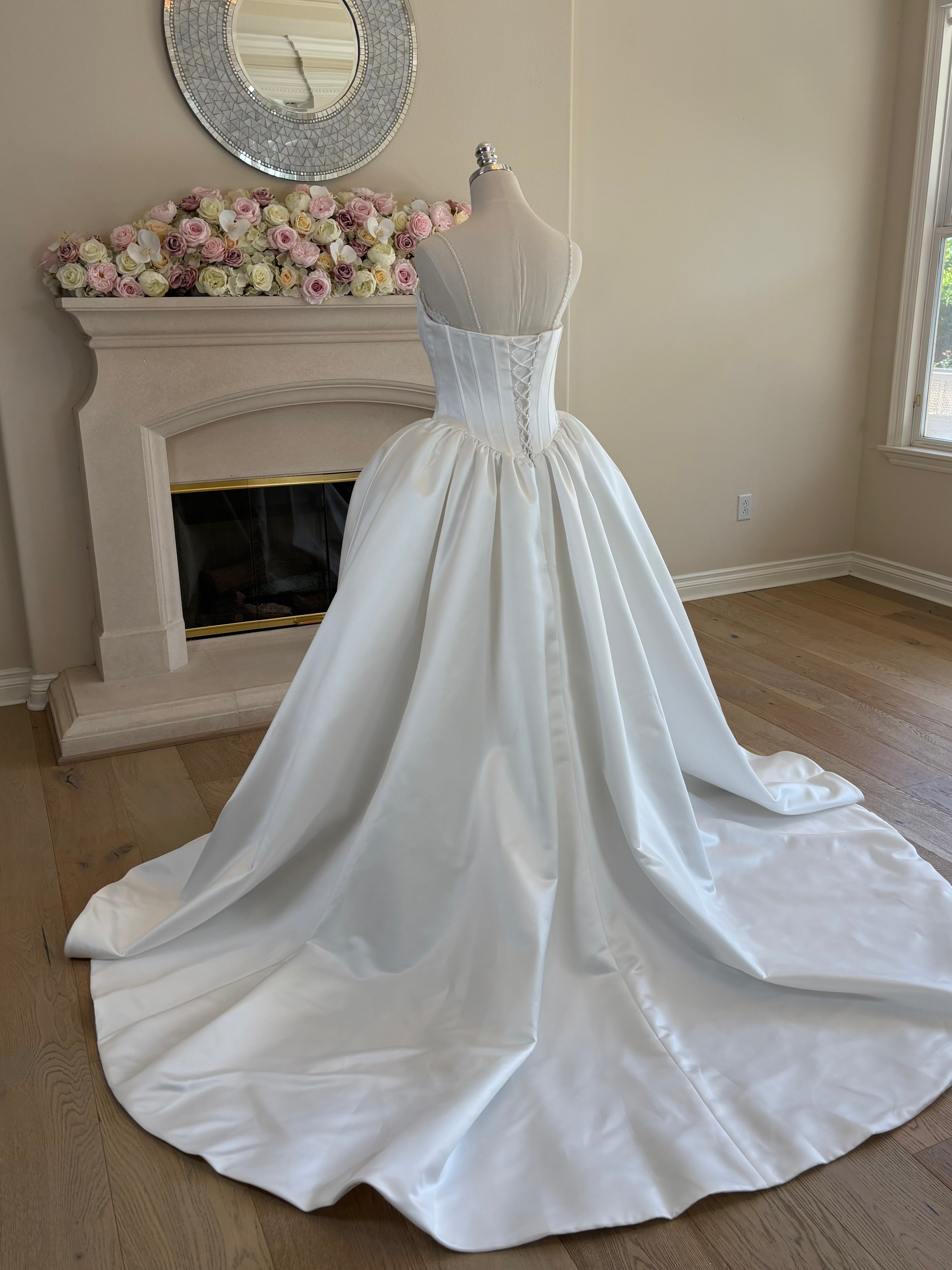 Back view of the chapel train of Amélie convertible French lace wedding dress with detachable Mikado corset overskirt, 