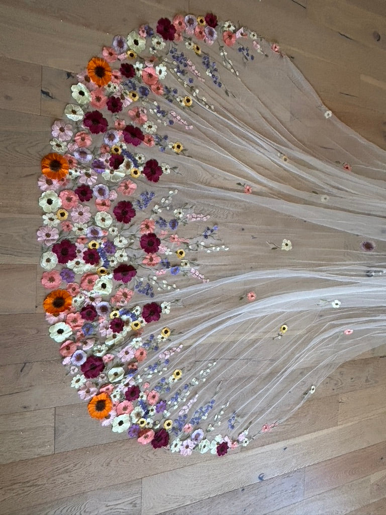 Overhead view of the multicolored embroidered wildflower border on the Meadow Reverie veil