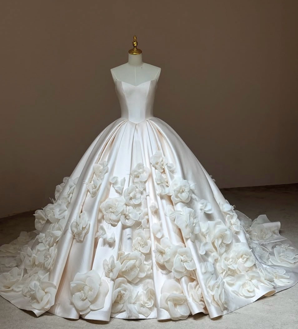 Camellia Royale premium Mikado satin ball gown with a pointed basque waist, sweetheart neckline, and handmade 3D floral skirt.