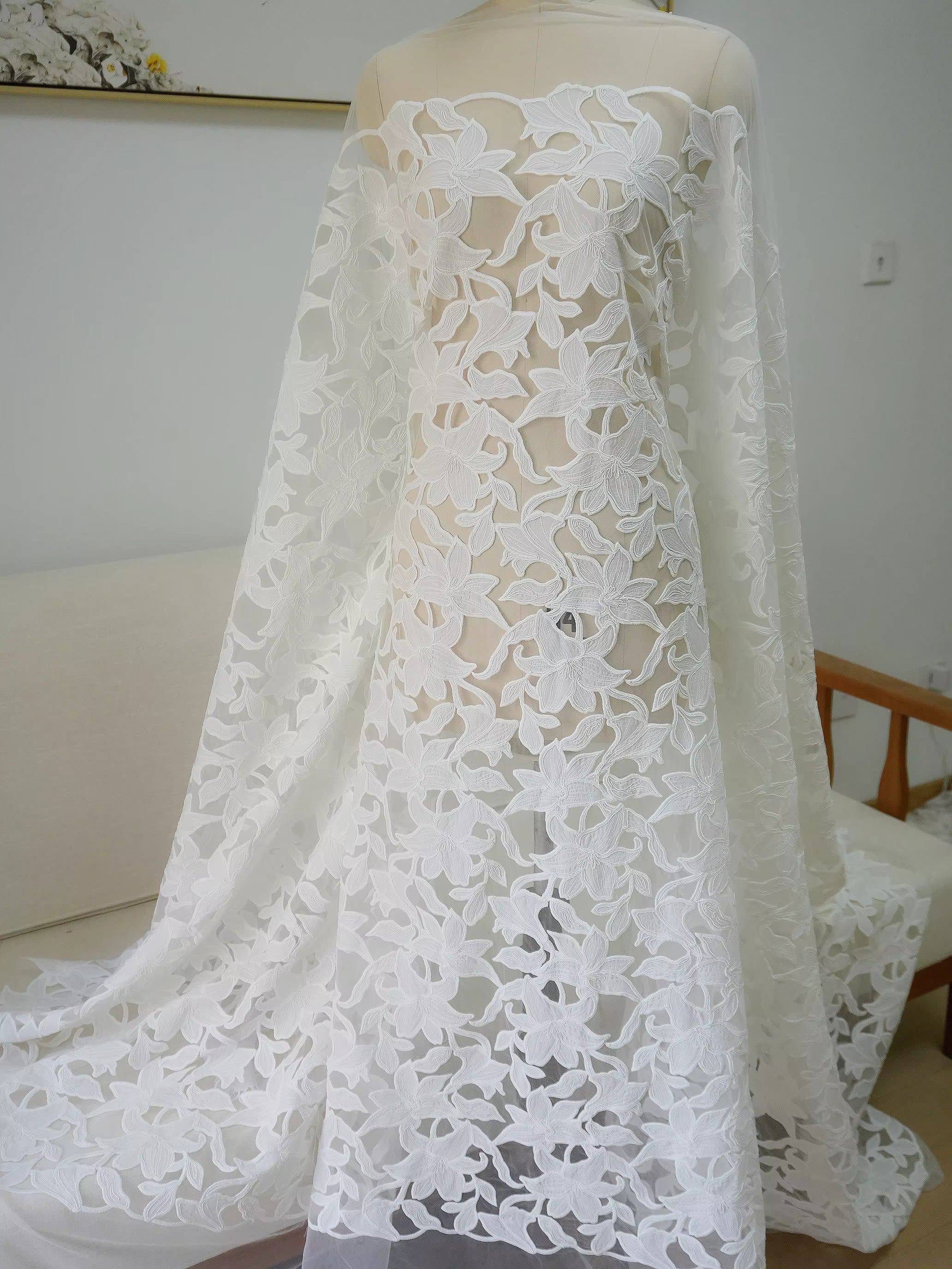 Close up of embroidered lace fabric used to make Solenne