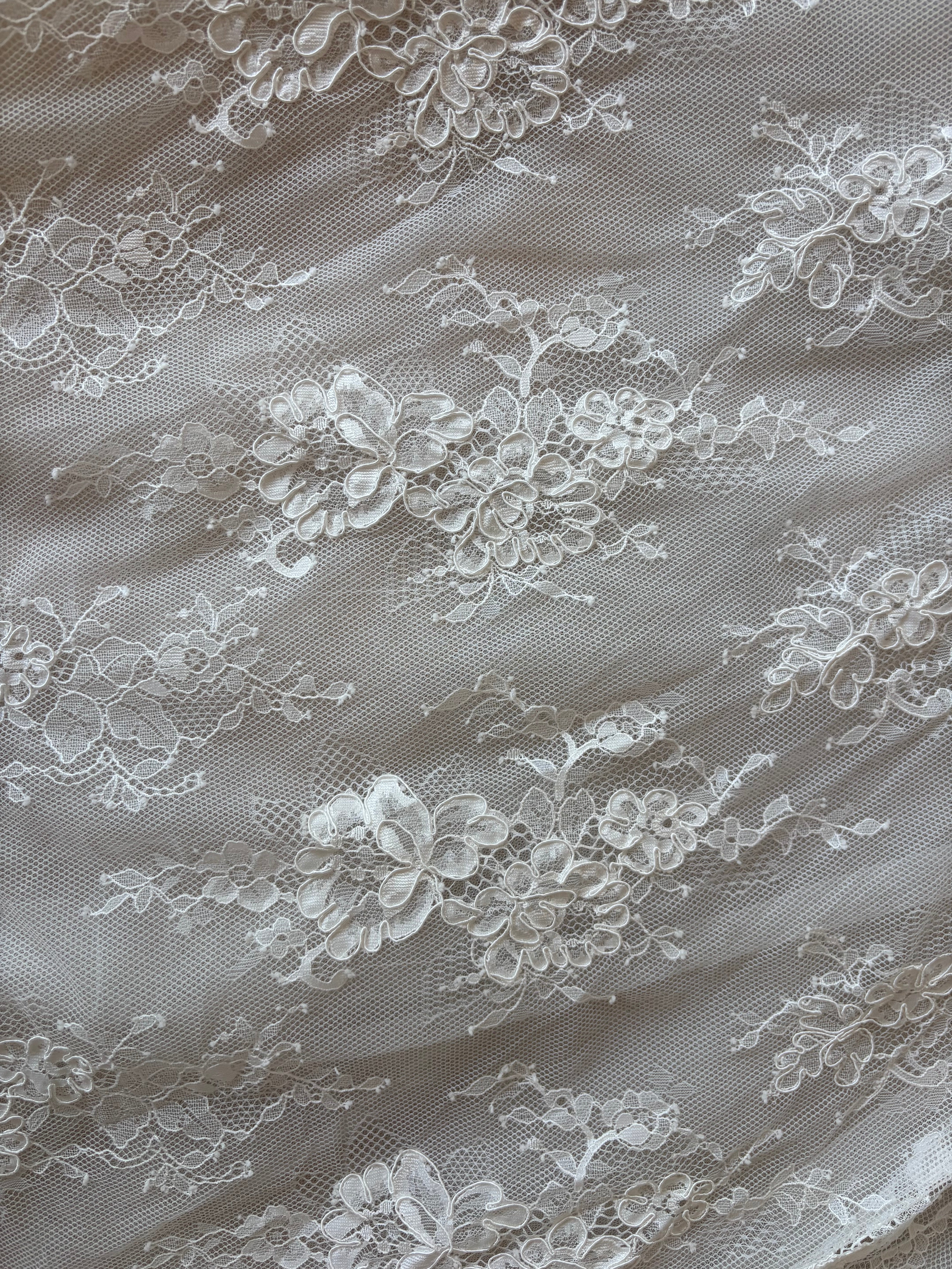 Close up of corded french lace fabric used to create Odette gown.