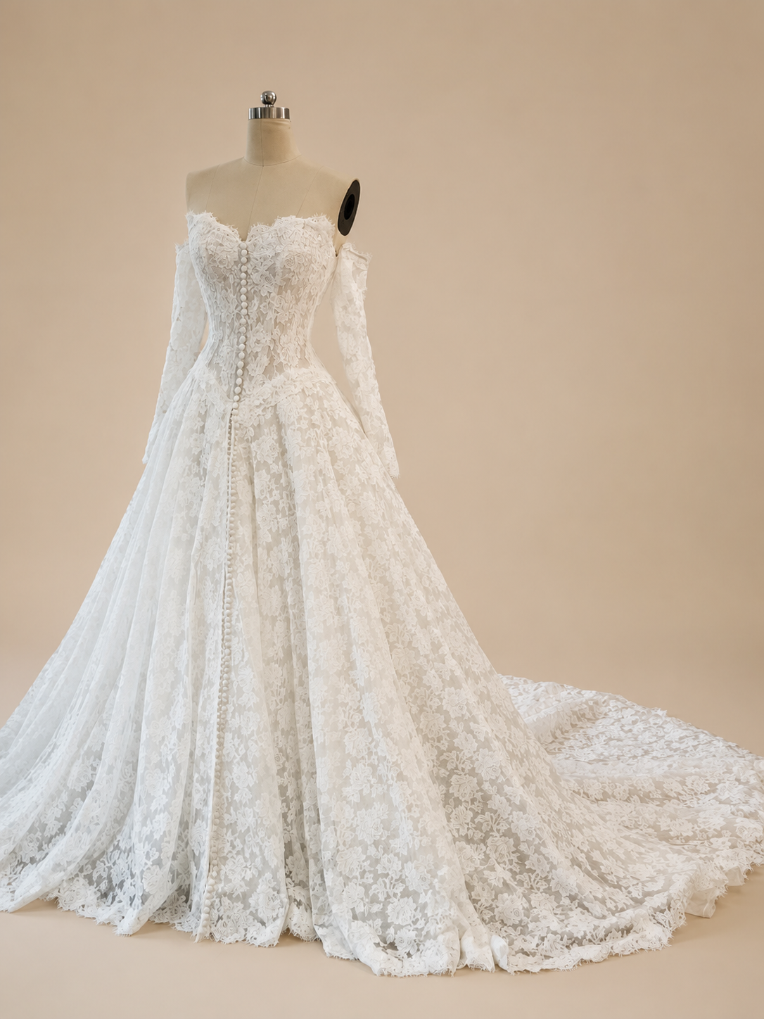 Three-quarter view of Estelle A-line French lace wedding dress with detachable long sleeves and chapel train