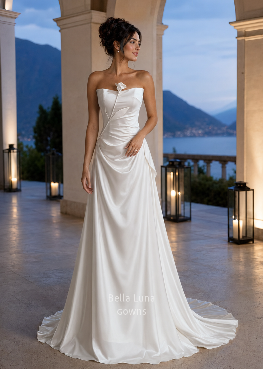 Bride wearing the Tulip off-white fitted satin wedding dress with a handmade sculptural flower and court train.