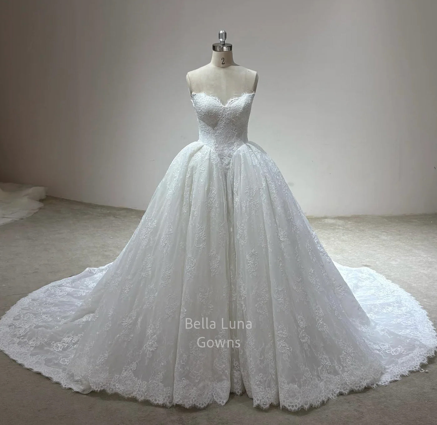 Front view of Odette off-white lace bridal ball gown with sweetheart neckline, full skirt