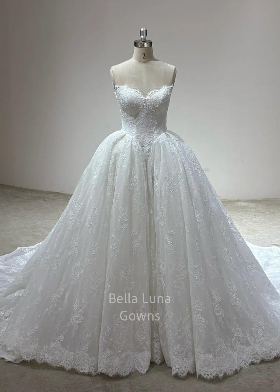 Odette off-white corded French lace bridal ball gown with sweetheart neckline, full skirt and court train